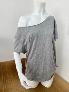 Off The Shoulder Slouchy T Shirt 100% Cotton Raw Cut Neck and Sleeves Traditional Hem  The off-the-shoulder cotton slouchy T-shirt is a piece that embodies both comfort and style. Handmade from 100% cotton fabric, it offers a natural and breathable feel. The raw cut neckline and sleeves, along with the traditional hem at the bottom, create a relaxed yet stylish look that can easily transition from casual outings to yoga or gym sessions. With availability in a wide variety of colors, this T-shirt provides options for individuals to express their personal style preferences. Its off-the-shoulder design adds an alluring touch while maintaining comfort, making it a versatile choice for different occasions. SIZE GUIDE USA XS fits US Sizes 4 Small Fits US Sizes 6 Medium Fits US Sizes 8 Large Fits Shirt Hanging Off Shoulder, Off The Shoulder Outfit Casual, Loose Off The Shoulder Top, Off The Shoulder T-shirt, One Shoulder T Shirt, Off Shoulder Cut Shirt, Cut Shoulder Shirt, Off Shoulder Baggy Shirt, Basic Clothes For Women