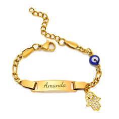 a gold bracelet with an evil eye and hamsah charm on the side, that says