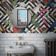 a white sink sitting under a mirror in a bathroom