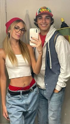 a man and woman taking a selfie in the bathroom