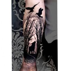 a man's arm with a deer and birds on it