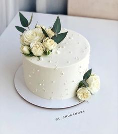 there is a white cake with flowers on it