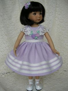 a doll wearing a purple dress and white shoes