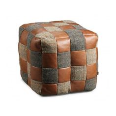 a brown and black checkered ottoman sitting on top of a white floor