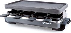 an image of a grill that is cooking on the griddle with trays attached to it