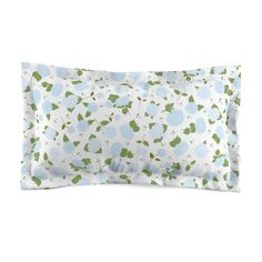 an image of a pillow with blue flowers on the front and green leaves on the back