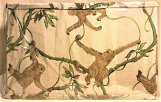 the monkey is hanging upside down on the curtain