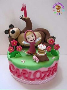 a birthday cake decorated with an animal and girl