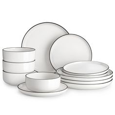 the white dishes are stacked on top of each other