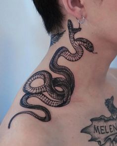 a woman with a tattoo on her neck has a snake tattooed on the back of her neck