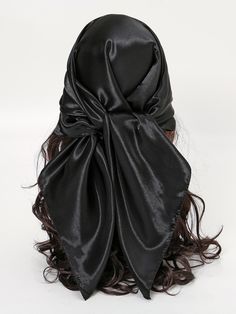 a woman's head wrapped in a black satin material covering her face and hair