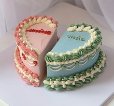 two heart shaped cakes sitting on top of a white countertop next to each other