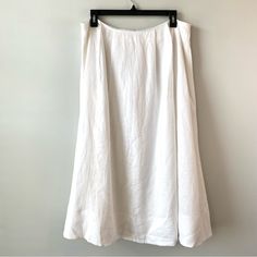 a white skirt hanging on a wall