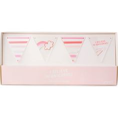 a pink and white box with three pennants on it that say believe, i'm wonderful