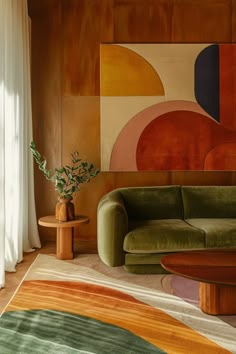 a green couch sitting in front of a painting on the wall next to a table