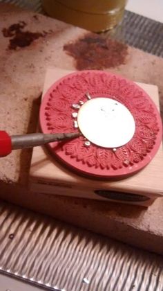 a red and white plate sitting on top of a wooden block