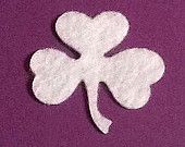 a four leaf clover on a purple background