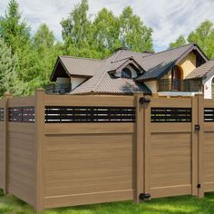 a large wooden fence in front of a house