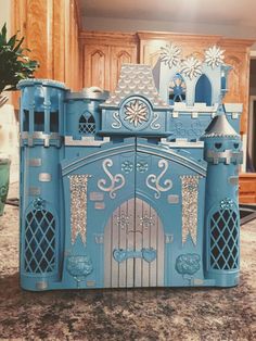 a blue toy castle sitting on top of a counter