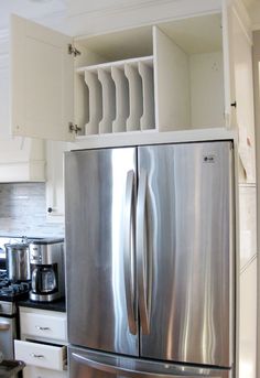 a stainless steel refrigerator in a white kitchen