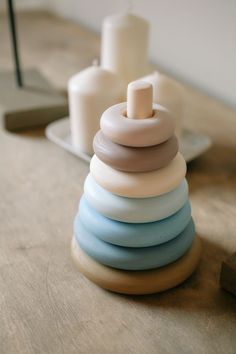 a stack of candles sitting on top of a wooden table