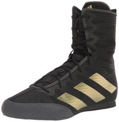 the adidas basketball shoe is black with gold stripes on the upper and bottom part