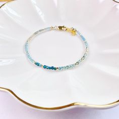 Elevate your style with our dainty Apatite bracelet, crafted with delicate 2mm cube gemstones. This nature gemstone jewelry offers minimalistic charm and crystal healing protection. Give the gift of love and positive energy to your loved ones today! Add a touch of elegance to your look with our delicate 2mm cube gemstone bead bracelet featuring dainty Apatite stones. Embrace the beauty of nature with this minimalist jewelry piece, offering crystal healing properties and protection. The perfect g Delicate Adjustable Gemstone Beaded Bracelets, Dainty Blue Bracelets With Natural Stones, Dainty Blue Gemstone Beaded Bracelets, Blue Dainty Gemstone Beaded Bracelet, Adjustable Dainty Rondelle Bracelet, Handmade Dainty Rondelle Beaded Bracelets, Dainty Handmade Rondelle Beaded Bracelets, Apatite Bracelet, Jewelry Nature