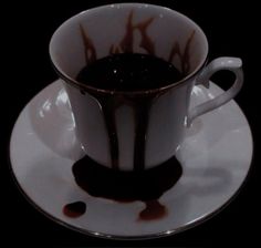 a white and black coffee cup with saucer