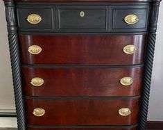 an antique chest of drawers with brass pulls and knobs on the top, in dark wood