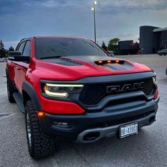 a red ram truck parked in a parking lot