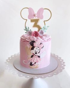 a pink and gold minnie mouse birthday cake