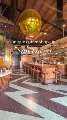 the inside of a coffee shop with tables and stools