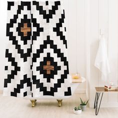 a black and white shower curtain with wooden crosses on it