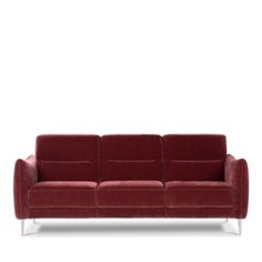 a red couch sitting on top of a white floor