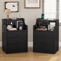 two black nightstands with electronic devices on them