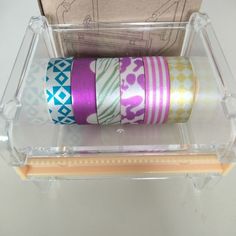 several rolls of washi tape in a clear container