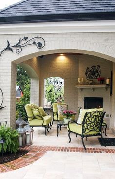 an outdoor living area with chairs and tables