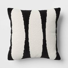 a black and white striped pillow sitting on top of a table