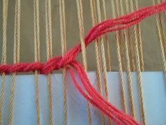 the red thread is being used to weave fabric