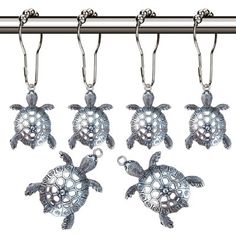 six sea turtle key chains hanging from a hook on a metal bar with chrome finish