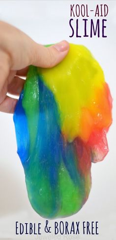 a hand holding a gummy bear with the words slime on it and an image of