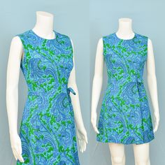 "Gorgeous! 60s vintage sleeveless dress has a round neckline, darted bust, tapered waist, self belting, and 5 gored skirting with front pleat + a line like flare. Mid weight linen in green, blue, lavender, and white paisley print. Fully lined with lightweight cotton. Non-stretch. Metal back zipper. Etsy compresses pics - click 'zoom' for best view.  MEASUREMENTS:  Bust: 33\" - snug 34\"  Waist: 26\" Hip: 37\" Shoulder to Shoulder: 13 1/4\"  Armsyce: 17 1/4\"  Total Length: 33\" shoulder seam to hem  TAG SIZE: n/a EST. MODERN SIZE: Extra Small to Small. See measurements. LABEL: n/a CONDITION: Excellent. No stains, rips, holes, busted seams, or fades. Steam sanitized prior to listing. No strong odors, but dry cleaning prior to wear suggested. All sales final. Follow me on Instagram @cointrel 1960s Gogo Girl, 60s Gogo Fashion, 60s Gogo, Gogo Girl, Groovy Clothes, Fashion 1960s, Mini Blue, Paisley Print Dress, Paisley Dress