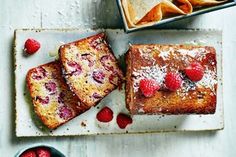 raspberry bread and other desserts on a white table with bowls of fruit