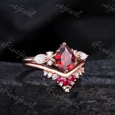 a close up view of a ring with red and white stones on top of it