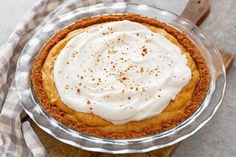 a pie sitting on top of a wooden cutting board