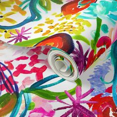 an abstract floral print on white fabric with multicolored flowers and leaves in the background