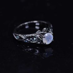 This piece has been inspired by natural forms of majestic glaciers, intricate elements of northern folklore and frozen creeks sparkling in the sun. All these elements woven together hold the main symbol of the north: stone clear as ice and bright like snow. Model 33-6 Moonstone Center Stone - Round 6 mm, Genuine, VVS1-Clarity, Ex-Cut, Ex-Polish, VG-Symmetry) and 8- Alexandrite Accents 0.1 CTW with 14K Black Gold or Black Platinum. Black Rhodium Plated. Please remember that you can customize this Unique Wedding Band Sets, Gothic Engagement Ring, Celtic Engagement Rings, Matching Wedding Rings, Black Engagement Ring, Black Stone Ring, Moonstone Engagement Ring, Gothic Rings, Unusual Jewelry