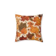 an orange and brown pillow with leaves on it