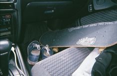 there is a skateboard and shoes in the car