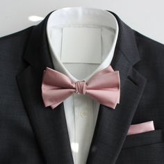 a black jacket with a pink bow tie